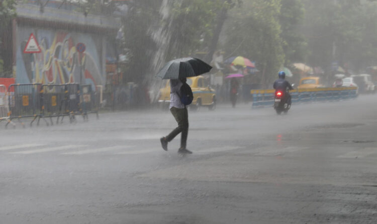 A man is crossing a road during heavy monsoon rain in Kolkata, India, on July 15, 2024. (Photo by Rupak De Chowdhuri/NurPhoto via Getty Images)